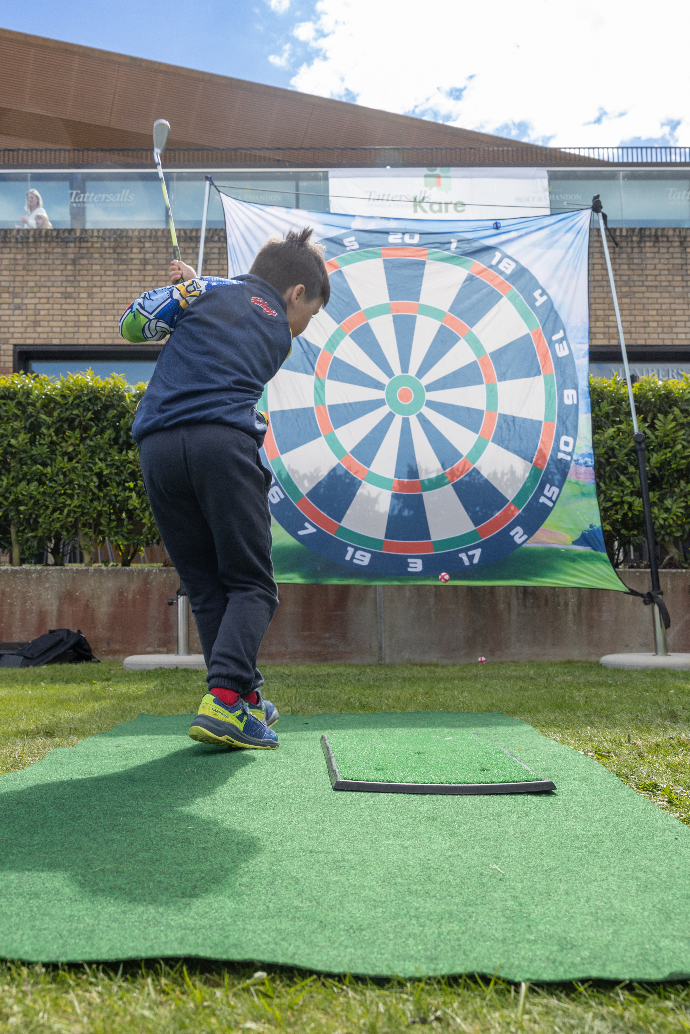 Child swinging golf club. 